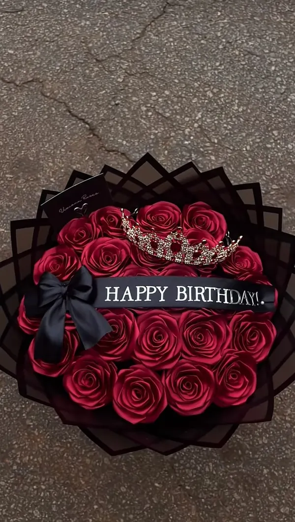 Round bouquet of red satin roses with a tiara and a Happy Birthday ribbon
