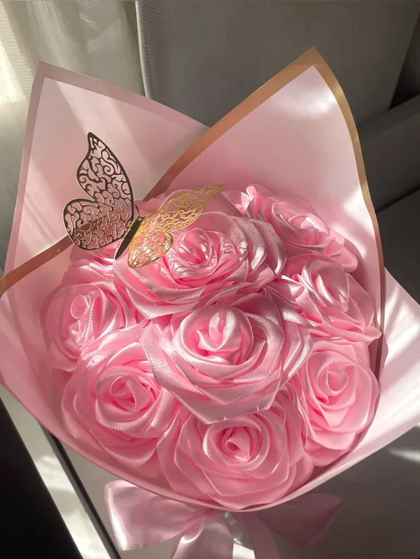 All-pink satin rose bouquet with a gold butterfly topper
