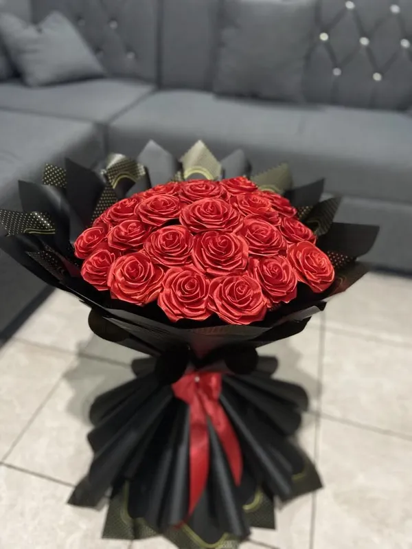 Large round bouquet of red satin roses in black wrap