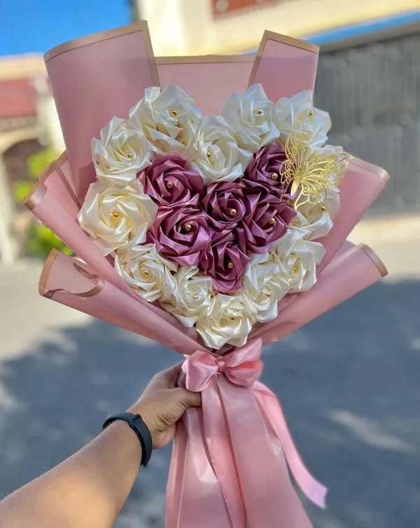 Ivory satin roses with a heart of wine-red roses in pink gold-edged wrap