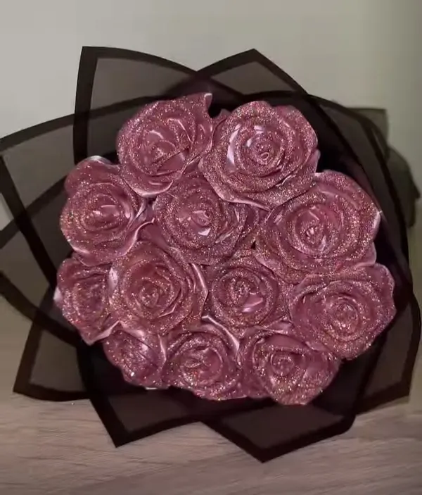 Glitter pink satin roses in sheer black wrap