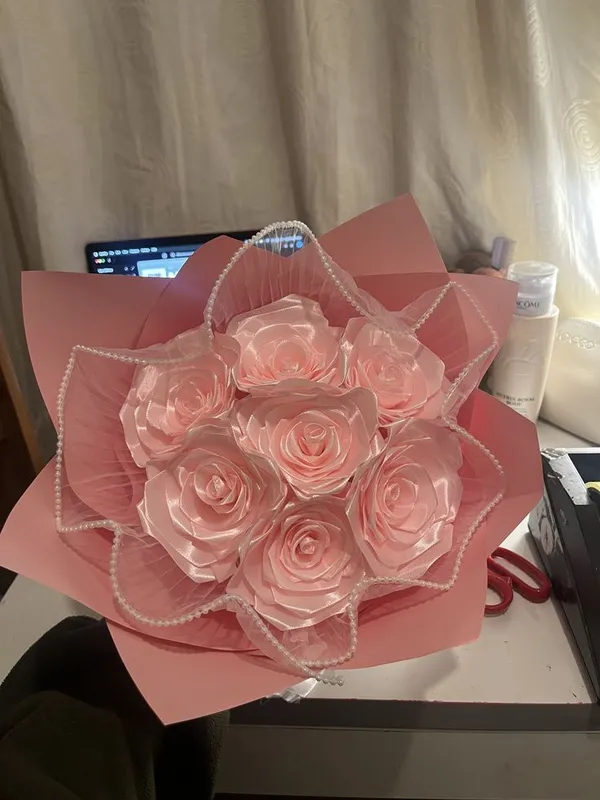 Peach pink satin roses framed with a pearl string in pink wrap