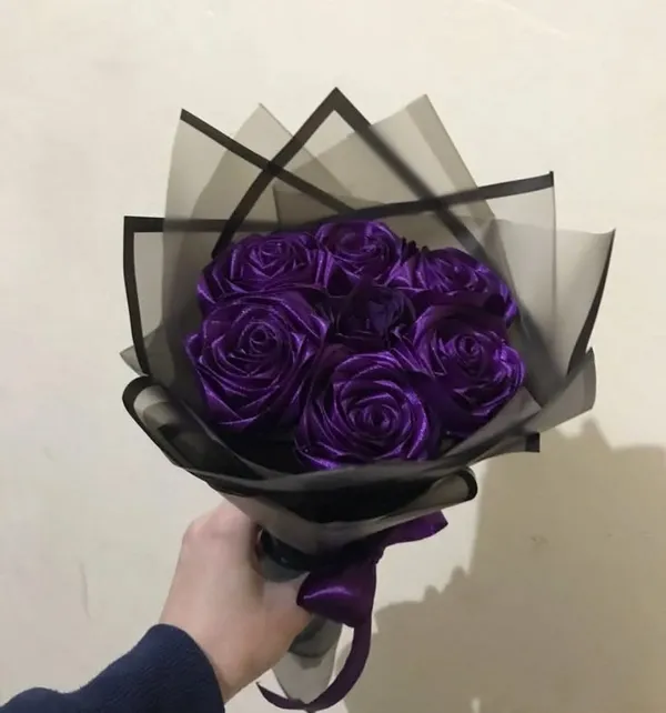 Purple satin roses in smoky black wrap