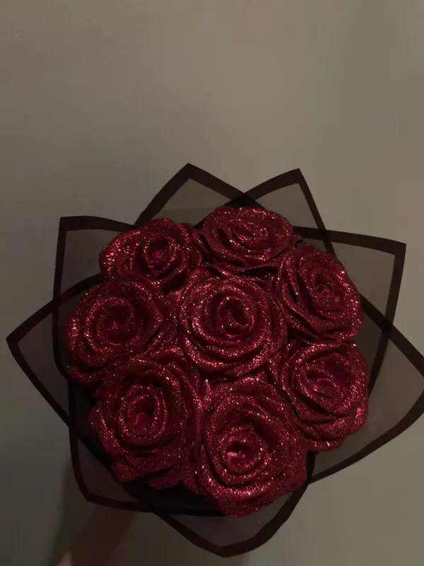 Glitter red satin roses in sheer black wrap