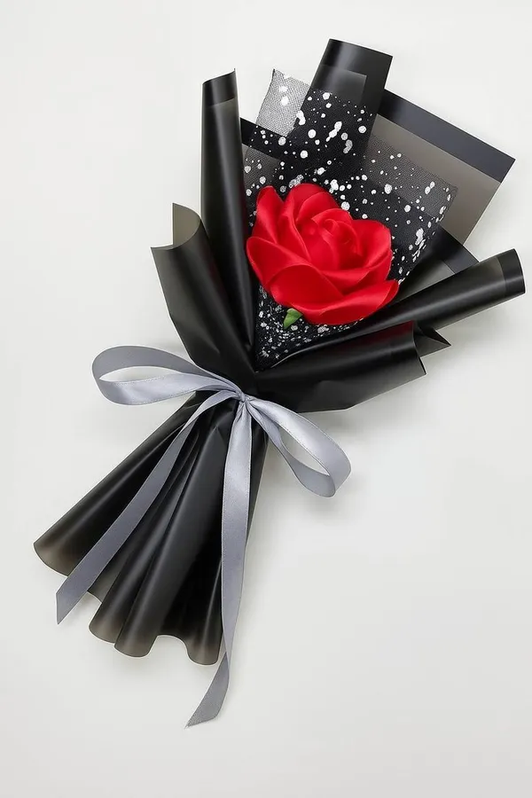 Single red satin rose in black wrap with a silver ribbon