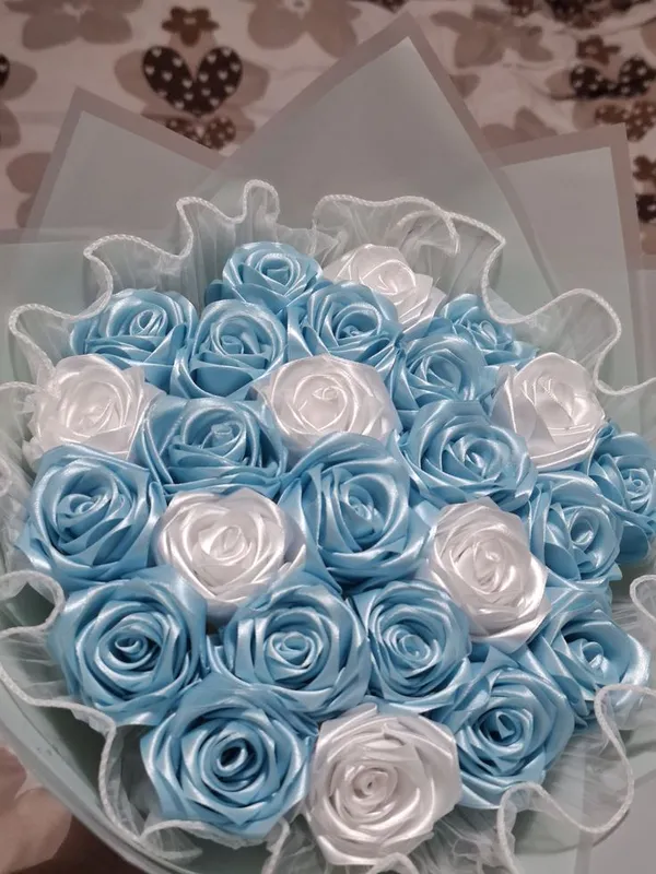 Baby blue and white satin roses in a frilled lace wrap